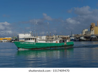 Honolulu, Hawaii, USA.  Sept. 29, 2019.  Bright Green Commercial Fishing Boat Departing Honolulu Harbor For The Southern Ocean Fishing Grounds.