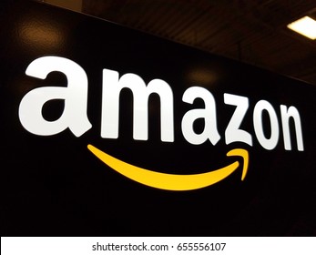 HONOLULU - JANUARY 12, 2017:  Amazon logo on black shiny wall in Honolulu Best Buy store.  Amazon is American international electronic commerce company. It's world's largest online retailer.