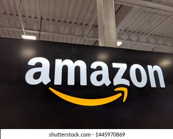 Honolulu -  March 16, 2019:  Amazon logo on black shiny wall in Honolulu Best Buy store.  Amazon is an American international electronic commerce company. It is the world's largest online retailer.