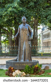 Honolulu  Oahu, Hawaii, USA. - January 10, 2012: Bronze statue of Queen Liliuokalani with plants in front and Banyan tree in back.
