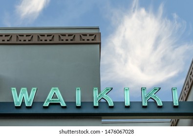 Honolulu, Oahu, Hawaii, USA - Waikiki Sign On The Building Roof Against Blue Sky - July 17. 2014