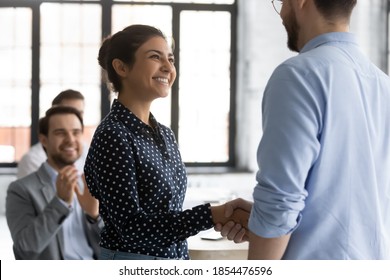 It is an honor to me. Glad smiling young lady corporate worker of indian ethnicity getting recognition acknowledgement of ceo, handshaking higher executive on briefing conference, being hired promoted - Shutterstock ID 1854476596