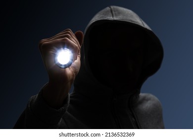 Hooded Burglar. Silhouette Of Thief And Flashlight