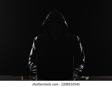 Hooded Hacker With Laptop At Night