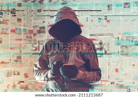 Hooded hacker person using smartphone in infodemic concept with digital glitch effect