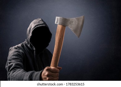 Hooded Man With An Axe In The Dark