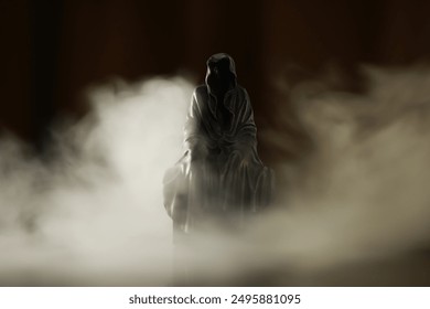 Hooded Mysterious Figure in Foggy Dark Atmosphere, Eerie Ambient Light - Powered by Shutterstock