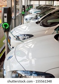 hoofddorp, the netherlands  July 4th 2013: row of electric vehicles at a charging station. the harlemermeer council policy is to maintain a large fleet of electric vehicles and provide free charging - Shutterstock ID 155561348