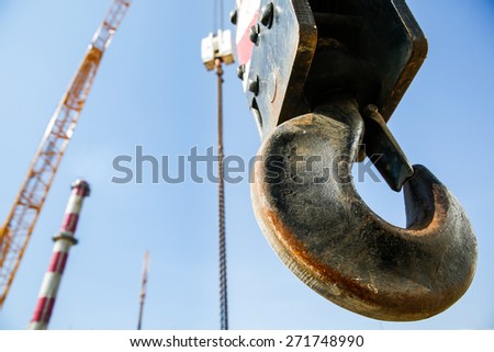 Hook of a mobile lifting crane on a construction site, capable of lifting 25 tons of load. Heavy duty machinery for heavy construction industry. 