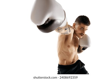 Hook. Muscular, shirtless young man, boxer training, fighting isolated over white background. Concept of professional sport, combat sport, martial arts, strength