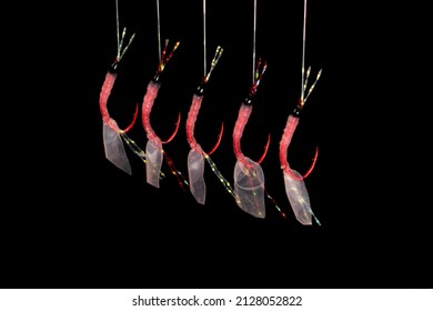 Hook For Salt Water Fishing Sports. Hook Isolated On Black Background. Fishing Hook Close Up. Fishing Tackle. Macro Shot Stainless Steel Fishing Red Hooks.