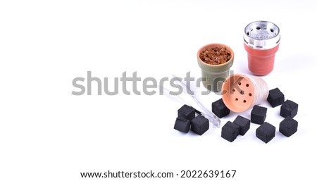Hookah bowls with tobacco and charcoal for smoking on a white background. Space for text. Banner