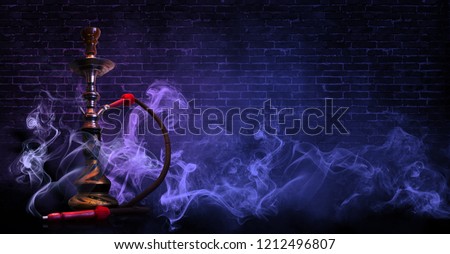 hookah on the background of a brick wall, neon light, smoke, smog,