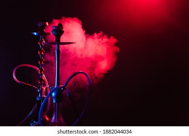 Hookah, Shisha On A Smoky Black Background With Neon Lighting And Smoke. Place For Your Text