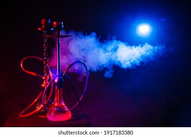 Hookah, Shisha On A Smoky Black Background With Neon Lighting And Smoke. Place For Your Text