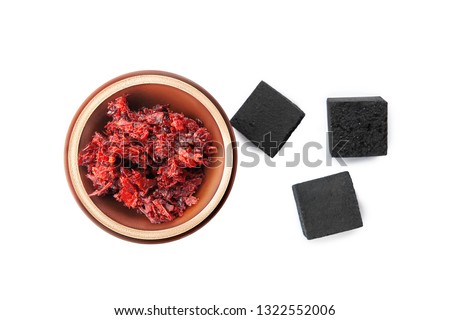 Hookah topic. Top view on clay bowl with red tobacco for hookah and coals isolated on white background. hookah bowl useful image for design with copy space
