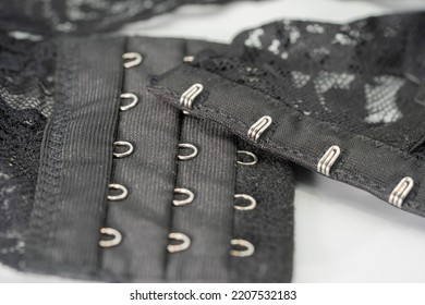 Hooks and lace on a bra close-up on a white background