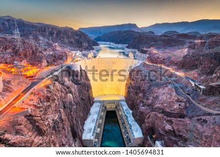 Hooover Dam on the Colorado River straddling Nevada and Arizona at dawn.