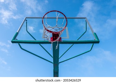 Hoop and backboard of a basketball hoop viewed from below