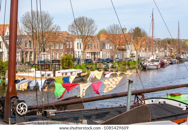 Hoorn, Netherlands - 4/9/2011: A load of washing\
hung out to dry on a clothes line on a boat tied up along a canal\
in HHoorn.