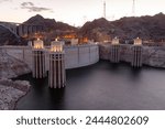 Hoover dam close-up shot. Hoover dam and Lake Mead in Las Vegas area. Large Comstock Intake Towers At Hoover Dam. Hoover Dam in the evening with illuminations without people.