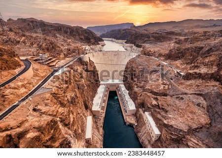 Hoover Dam on the Colorado River straddling Nevada and Arizona at dawn, from above.