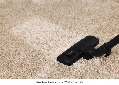 Hoovering carpet with vacuum cleaner, space for text