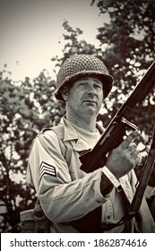 HOP FARM ,KENT,ENGLAND-22nd JULY 2010. WW2 US Soldier Attacks Enemy With His Tommy Gun During Battle Re-enactment.