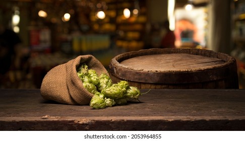 Hop twig over old wooden table background. Vintage style. Beer production ingredient. Brewery. Fresh-picked whole hops close-up. Brewing concept wallpaper. - Shutterstock ID 2053964855