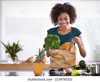 I hope the chef gets a kiss afterwards. Cropped shot of a young woman with some groceries. - Powered by Shutterstock