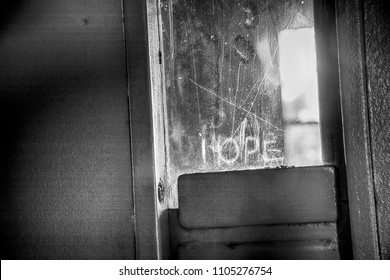 Hope Etched Into Window Of Solitary Confinement Cell Metal Door Inside Old Prison.