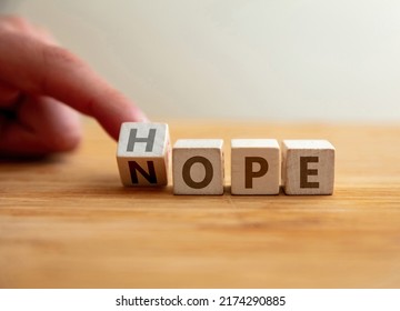 Hope Or Nope Concept. Finger Flips Letter At Wooden Cube Changing The Word Nope To Hope. Message For Modification From Pessimism To Optimism, Negative To Positive, Gain The Success.