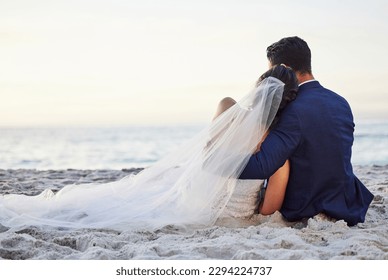 I hope we stay like this forever. Shot of a young couple on the beach on their wedding day. - Powered by Shutterstock