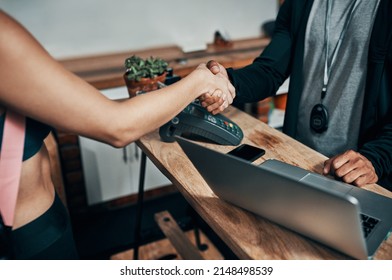 I Hope You Enjoy Our Services Here. Cropped Shot Of An Unrecognizable Male Fitness Instructor Shaking Hands With A Gym Member At The Reception Of A Gym.