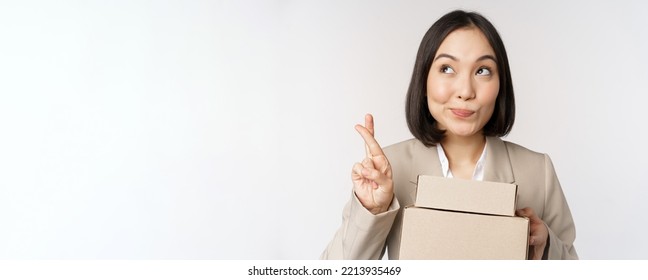 Hopeful Asian Entrepreneur, Business Woman Holding Boxes With Customer Order, Making Wish, Wishing And Anticipating, Standing Over White Background