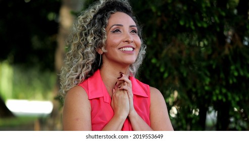 Hopeful Hispanic Woman Taking A Deep Breath Relaxing Outside Looking At Sky With HOPE And FAITH.