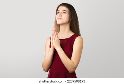 Hopeful Woman In Prayer Pose On Background