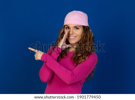 Hopeful woman wearing a pink scarf isolated on a white background