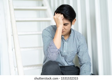 Hopeless Asian businessman sitting on the stairway. Stressed Asian businessman's portrait with copy space background. - Shutterstock ID 1531532315