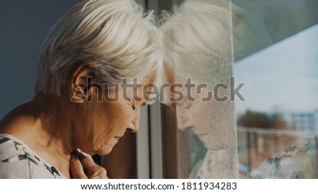 hopeless elderly woman, feeling loneliness during the lockdown. Vulnerable group and mental health issues. High quality photo