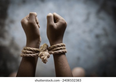 Hopeless man hands tied together with rope,  child labor concept, poor children victims of human trafficking process, poverty, child abuse. - Powered by Shutterstock