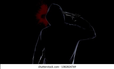 Hopeless man in hoodie shooting himself with pistol, bloody suicide and crime