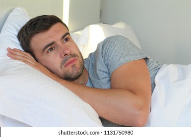 Hopeless man lying down in bed 