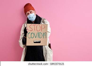 Hopeless Man Want Covid-19 To Be Stopped, He Is Suffering From Hunger And Cold, Wearing Dirty Clothes, Stand Looking At Camera, In Desperation