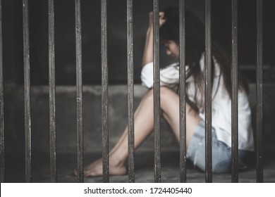 The Hopeless Slave Girl Is In A Cell. Women Violence And Abused Concept, Imprisonment, Female Prisoner,  Human Trafficking Concept, International Women's Day.