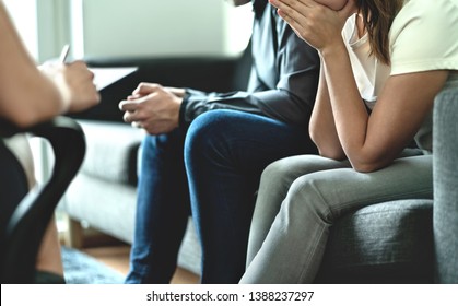 Hopeless and upset couple in therapy. Counseling or meeting with marriage counselor or adoption psychologist. Argument and dispute about divorce, alimony, prenup, cheating, betrayal or custody battle.