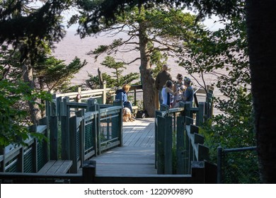 Hopewell Rocks, New Brunswick, September 17, 2018 -- Horizontal View Of Group Of People Looking At The Amazing Landscapes And Rock Formations At Hopewell Rocks, New Brunswick