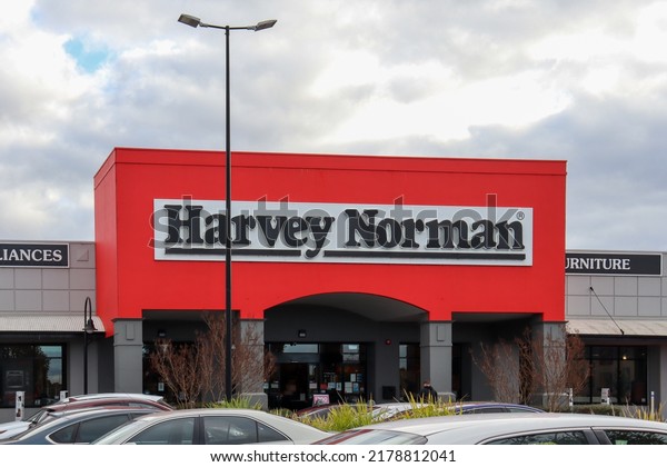 Hoppers\
Crossing, Vic Australia - July 15 2022: Harvey Norman home goods\
retail store front entrance and cars in car\
park