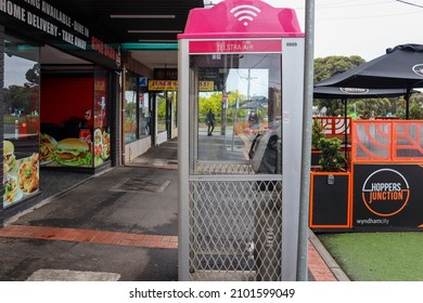 Hoppers Crossing, Vic Australia - October 23 2021: Telstra air phone booth on suburban shopping street with outdoor dining in background
