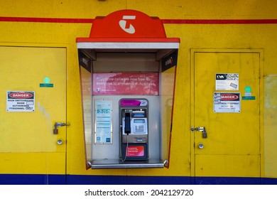 Hoppers Crossing, Vic Australia - Sept 16 2021: Telstra public telephone on dirty yellow wall